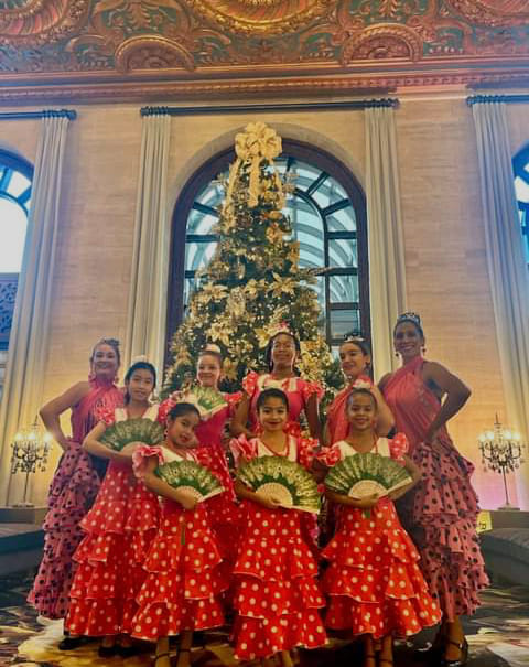 Flamenco dancers in front of holiday tree